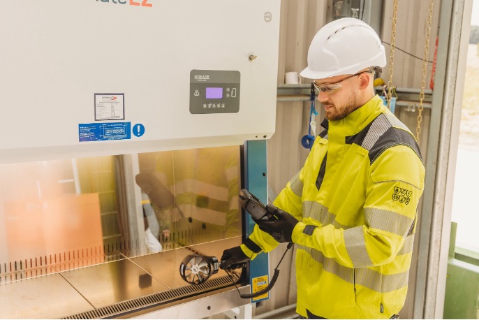 Armstrong Environmental specialist carrying out airflow testing on a biological safety cabinet