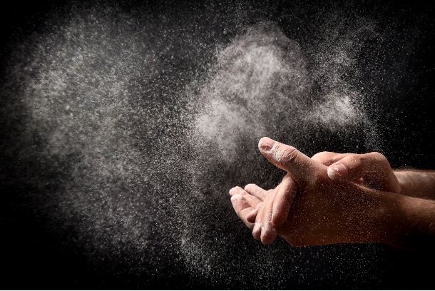 Airborne flour dust around hands during powder handling