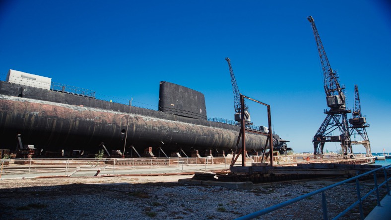 Submarine under construction within a complex marine-engineering environment
